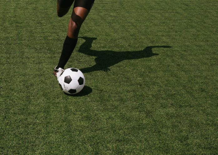 African soccer player kicking ball