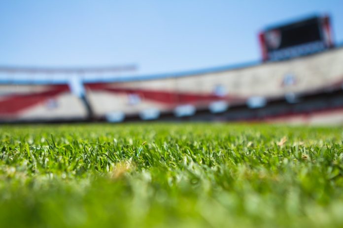 close up of grass in an empty football stadium