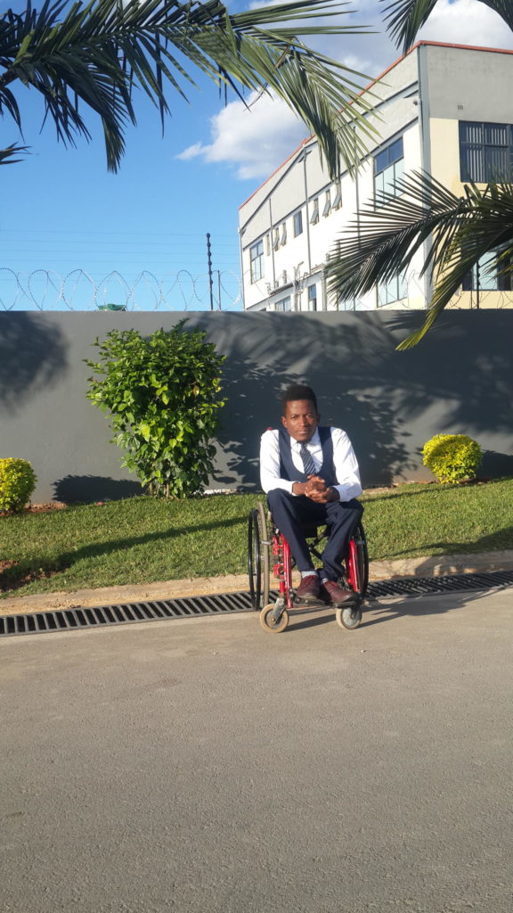 Chama Chansa sitting in his wheelchair in the streets of Lusaka